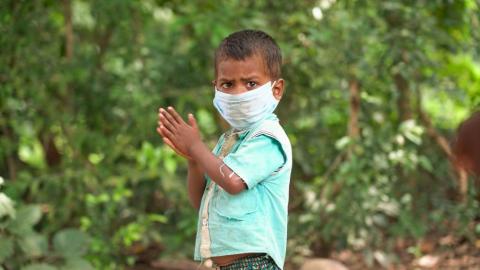 A Villager child wearing white mask