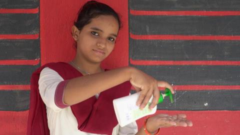 Girl holding a a handwasher