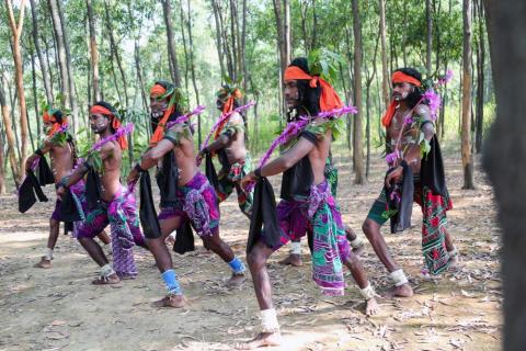 A group of tribal artist performing shikari dance with bow