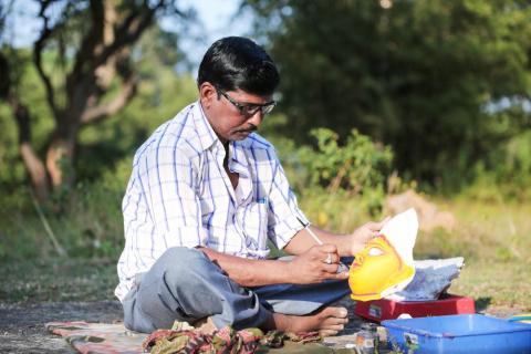 An artist painting face mask