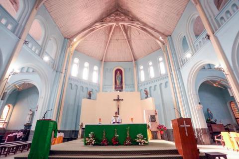 Father praying inside the church