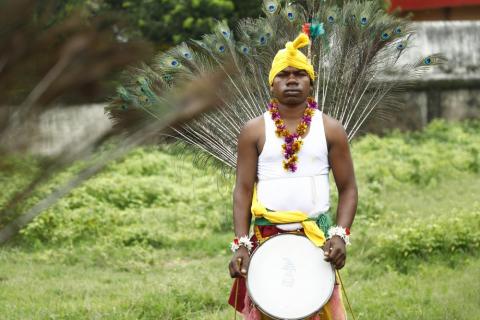 A tribal man playing drum